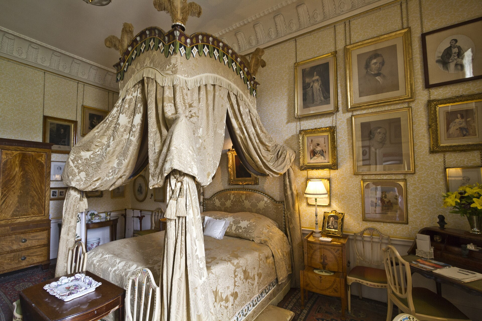 Lady Georgiana bedroom with canopy bed, paintings, and patterned textiles