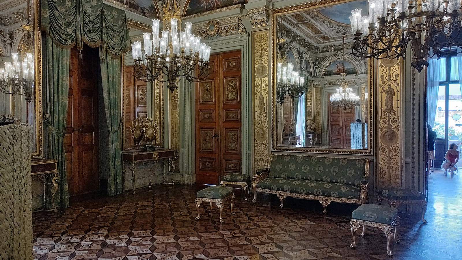 Green and gold salon at Palácio do Catete with mirrored walls, chandeliers, and parquet flooring