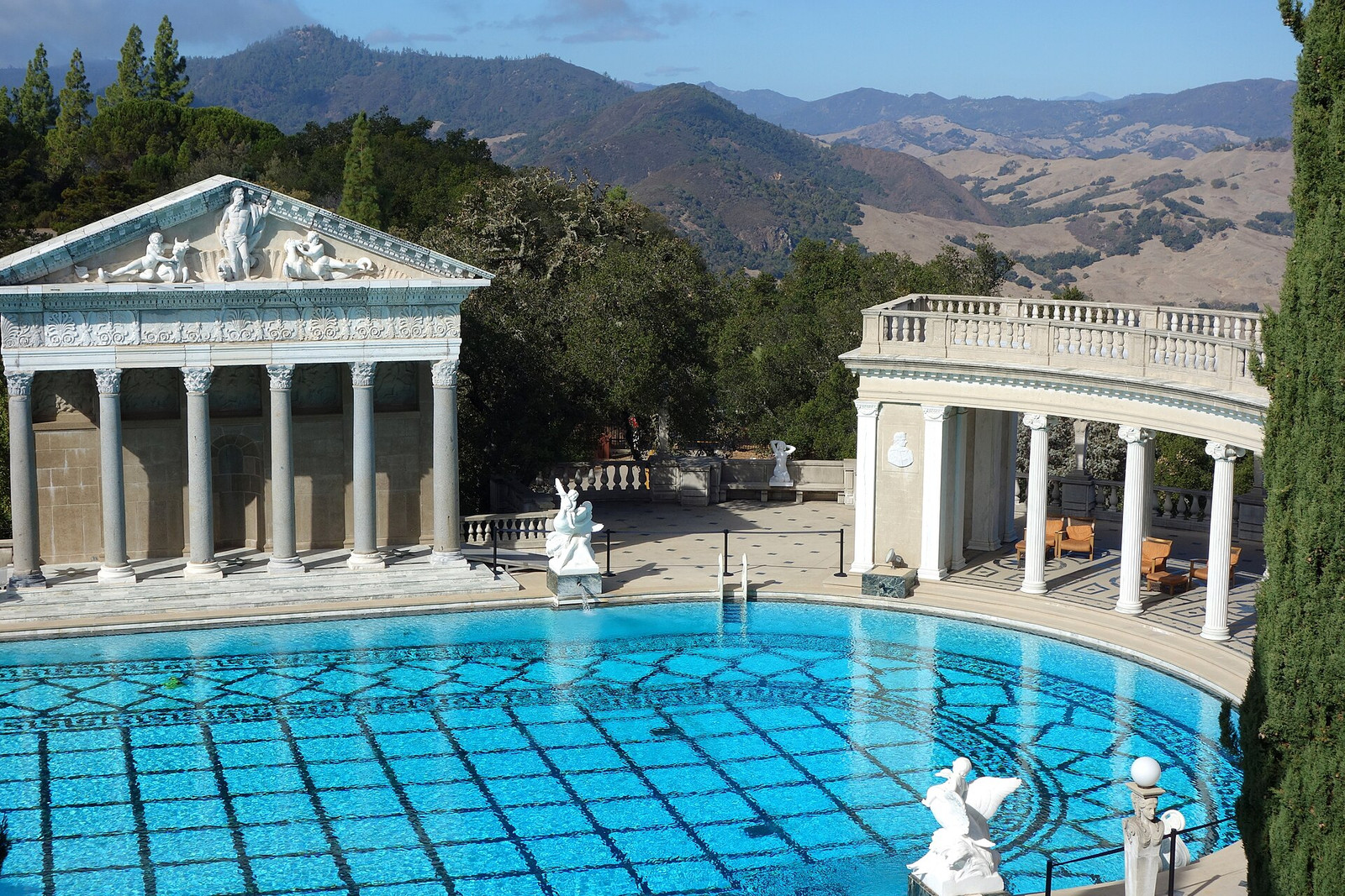 The outdoor Neptune Pool at Hearst Castle with colonnades and mountain views