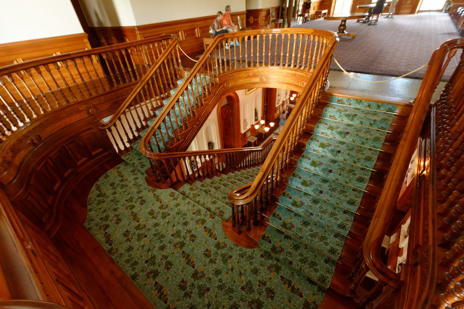 Koa staircase rising through the Grand Hall of ʻIolani Palace