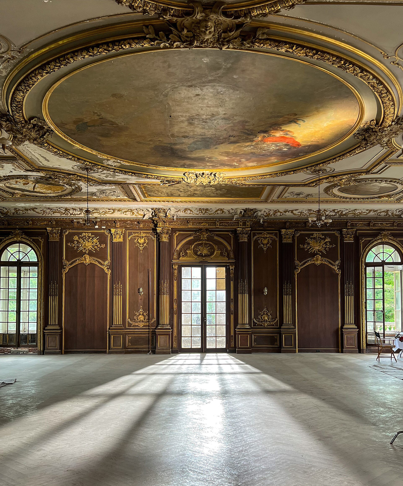The tall ballroom at Lynnewood Hall with arched openings and surviving plasterwork