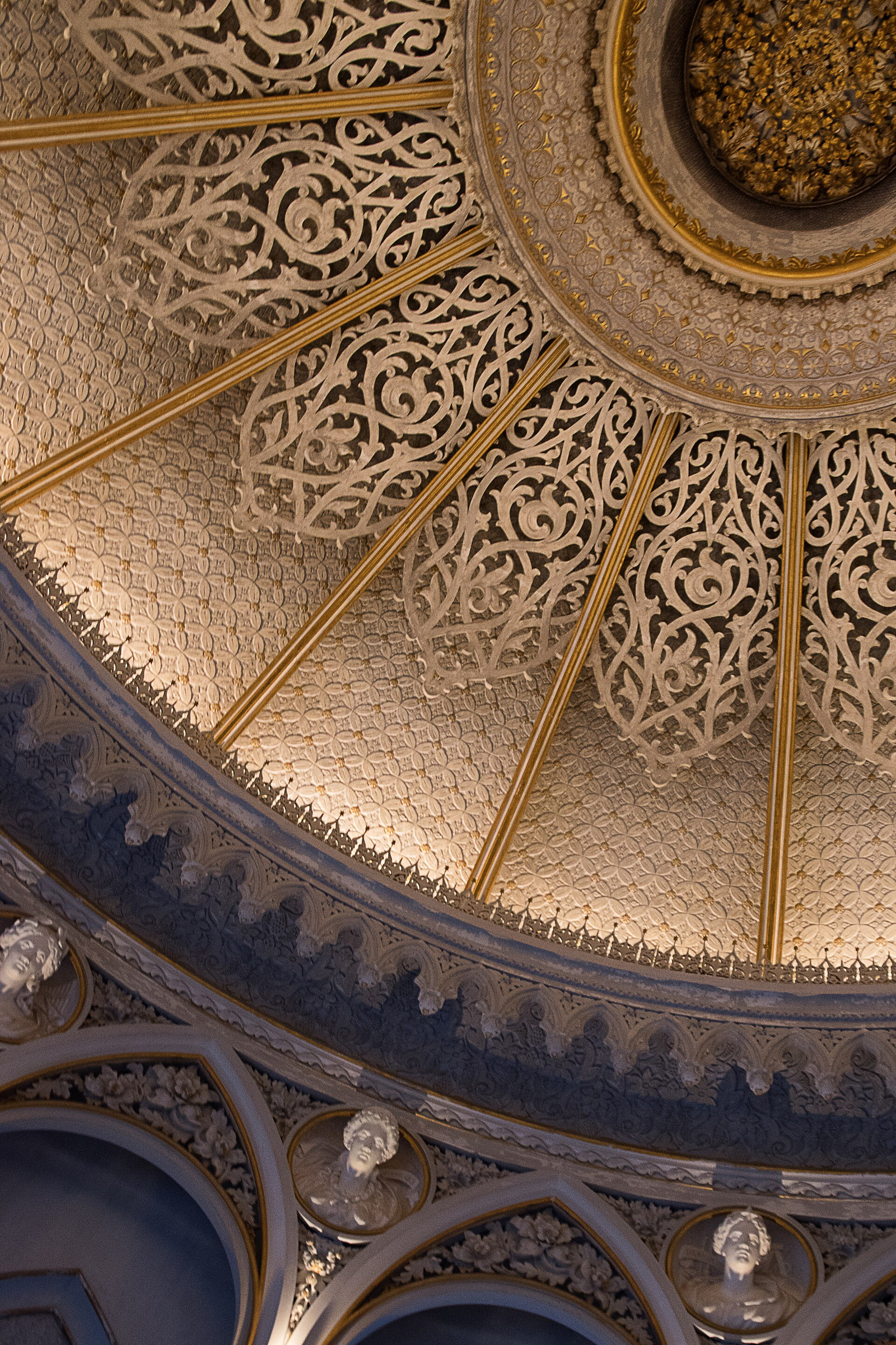 Close view of Monserrate ceiling ornament with repeating carved floral and geometric patterns