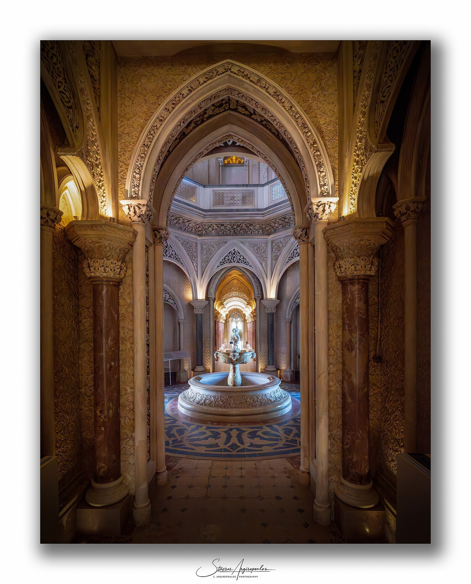 Monserrate’s central gallery with repeating arches, carved columns, and a fountain
