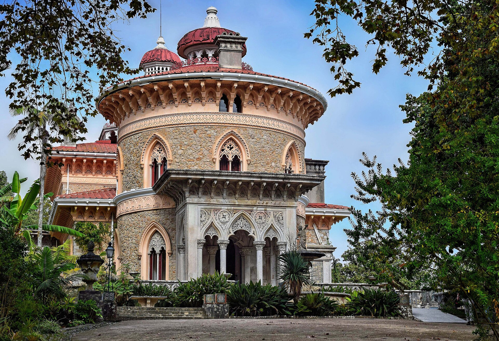 Round tower and carved entrance of Monserrate Palace framed by trees