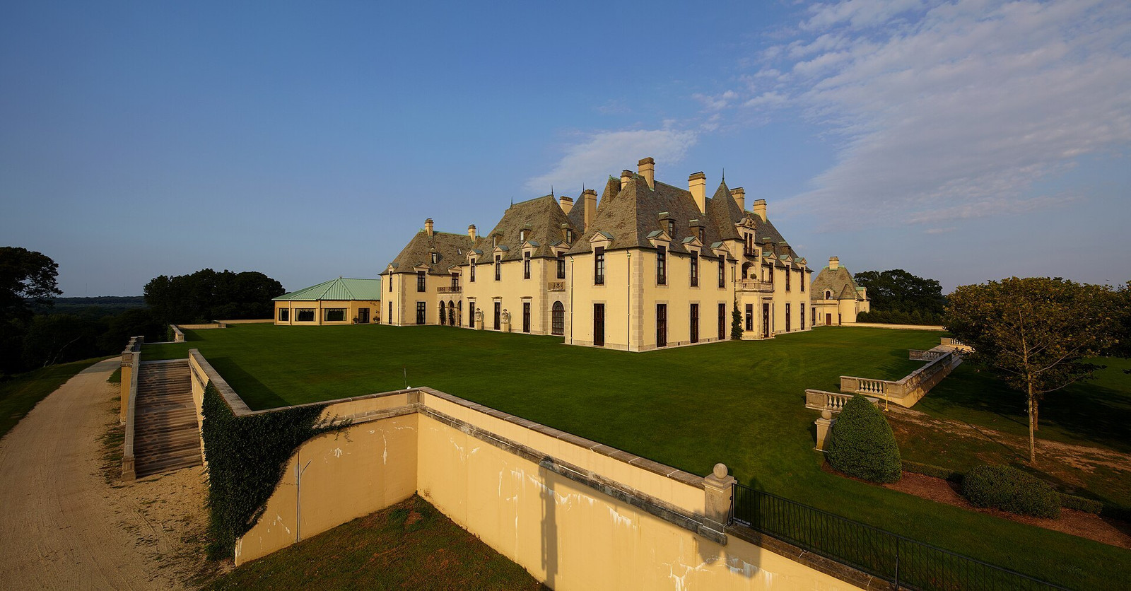Oheka Castle rising above broad lawns, stone terraces, and retaining walls