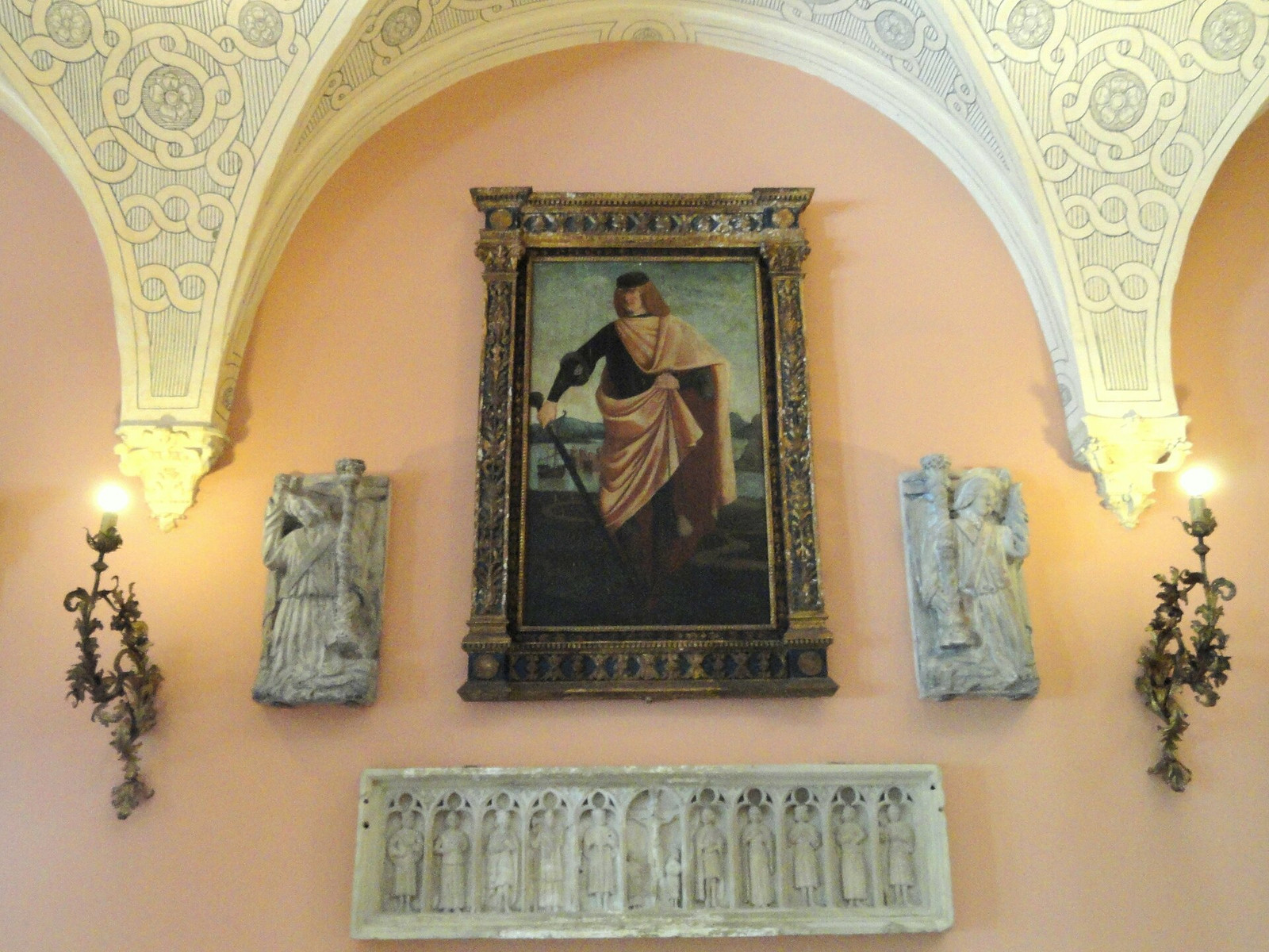 The interior patio at Villa Ephrussi with painted vaulting, pale stonework, sculpture, and a framed painting