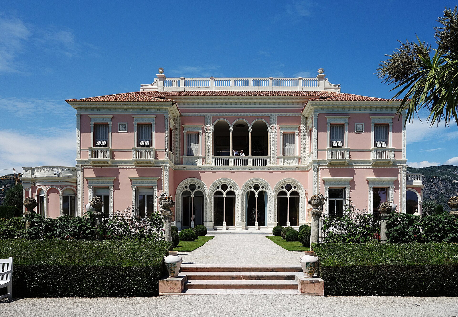The rose-colored south façade of Villa Ephrussi de Rothschild overlooking the formal French garden