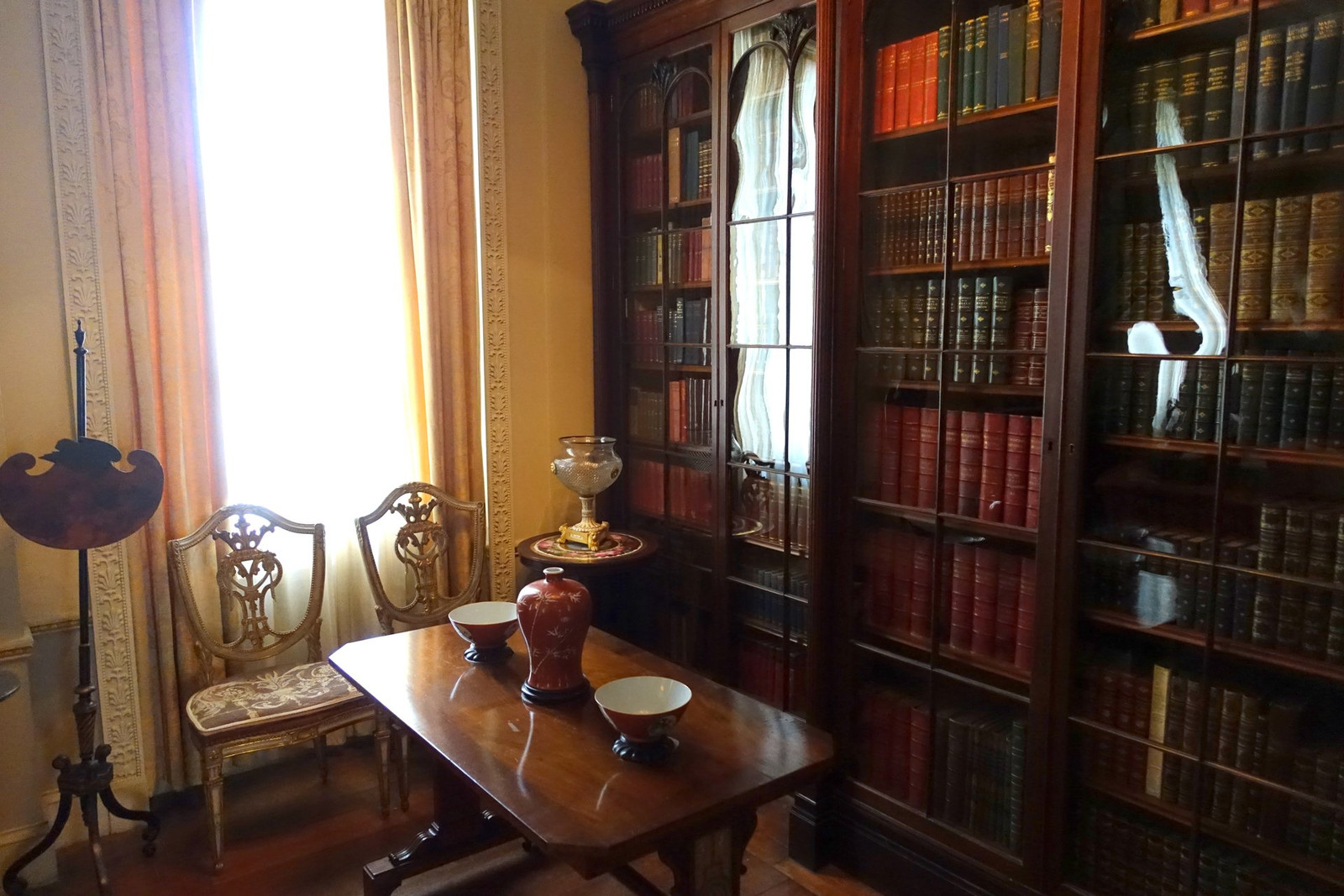 Vizcaya library with bookcases, carved wood, desk, and upholstered seating