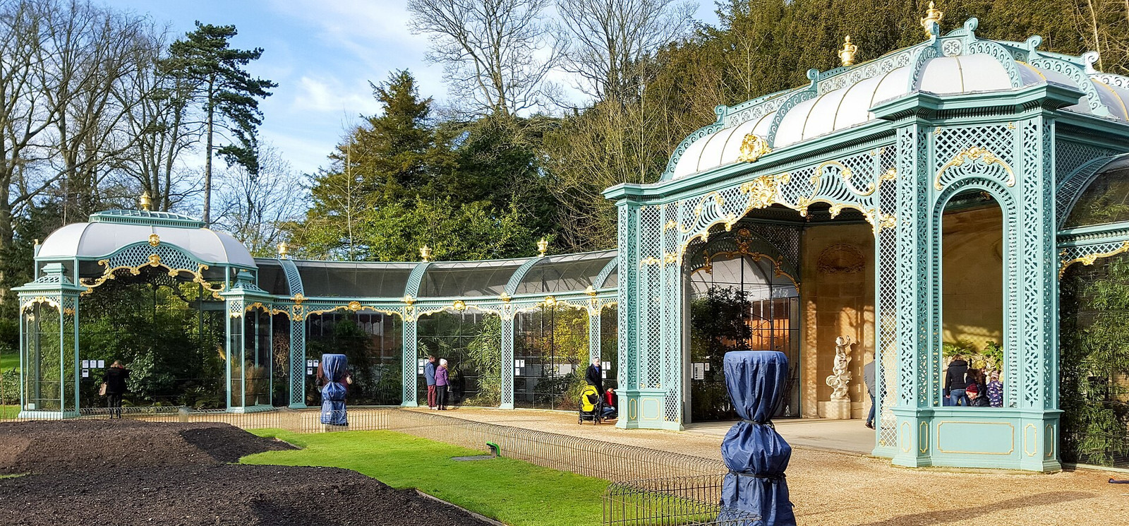 Ornate cast-iron aviary at Waddesdon Manor surrounded by gardens