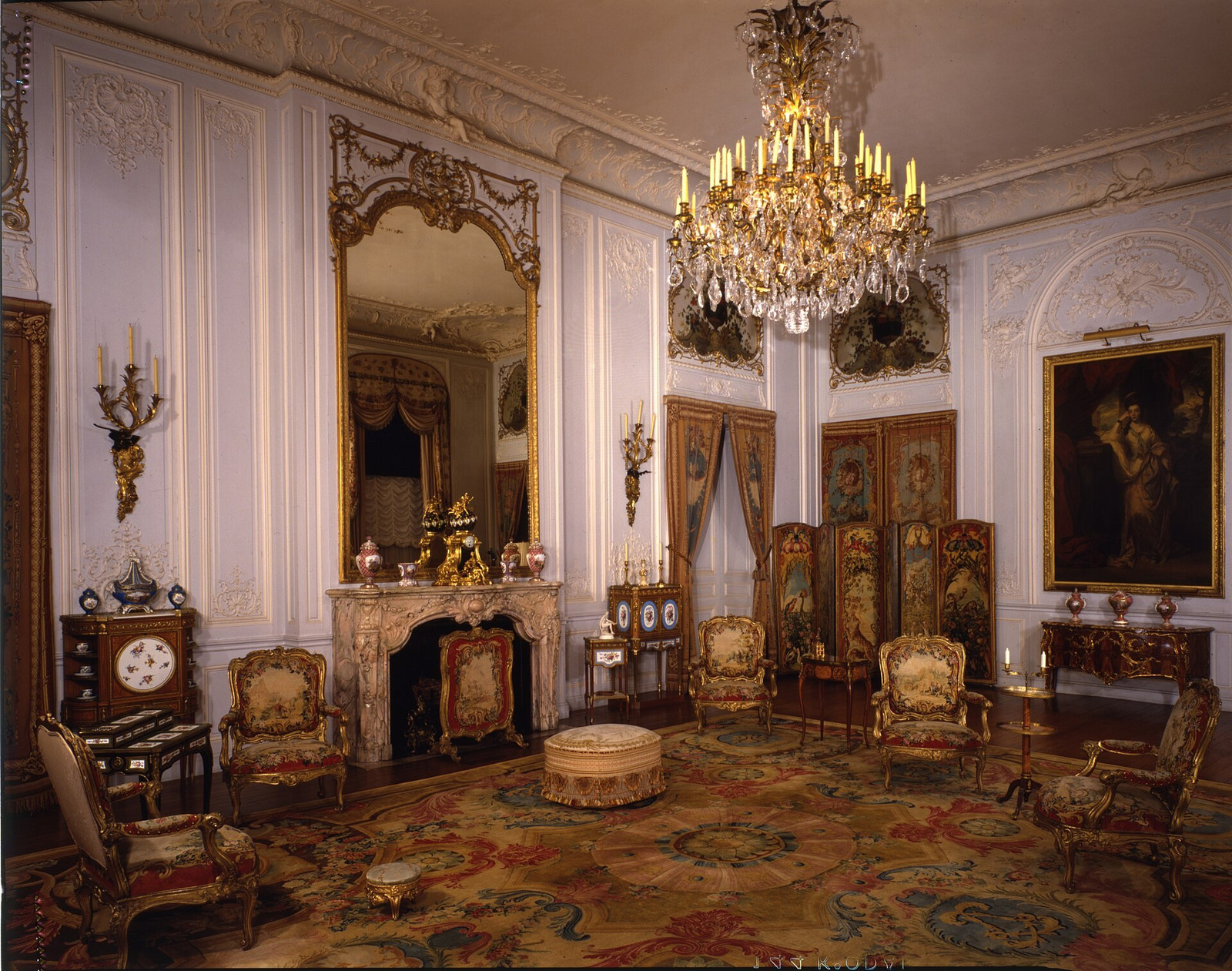Grey Drawing Room at Waddesdon Manor with pale panelling, gilded furniture, paintings, and a chandelier