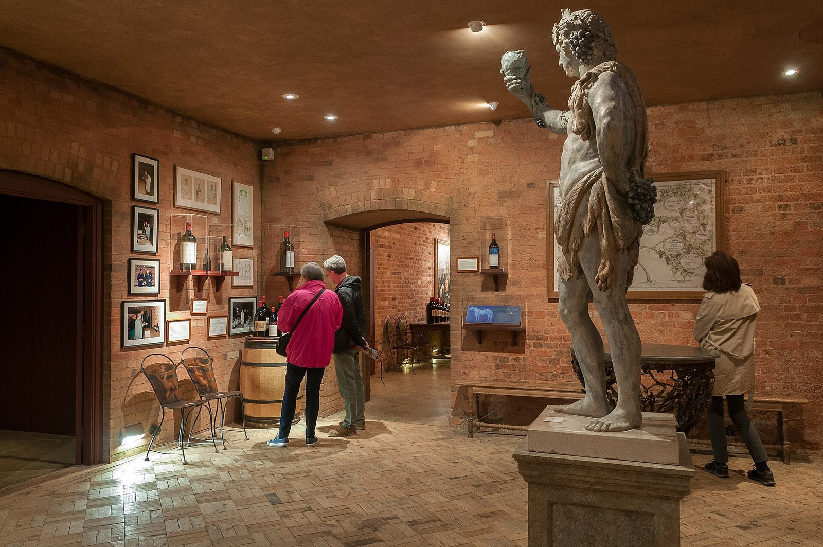 Arched wine cellars at Waddesdon Manor lined with racks and bottles